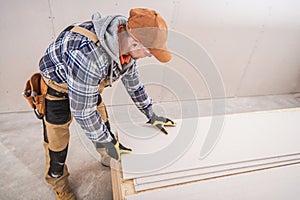 Male Construction Contractor Prepares Sheetrock Installation photo