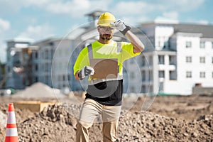 Male construction engineer. Architect at a construction site. Handyman foreman builder in hardhat. Building concept