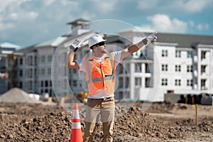 Male construction engineer. Architect at a construction site. Handyman foreman builder in hardhat. Building concept