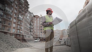 A male construction manager checks the quantity and checks the construction matral with documents at a construction site