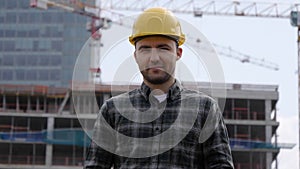 Male Construction Worker On Building Site Wearing Hard Hat.