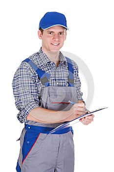 Male construction worker holding clipboard
