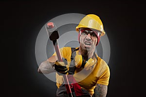 The male construction worker with a sledgehammer