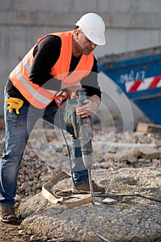 Male construction worker using jackhammer