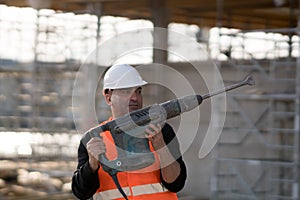 Male construction worker using jackhammer