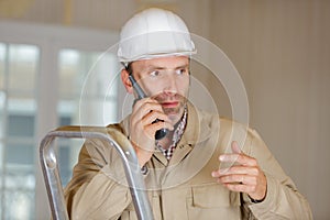 male construction worker using walkie talkie