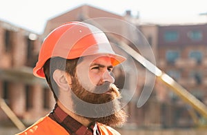 Male construction worker in work clothes and a construction helmet. Industrial theme. Young businessman construction