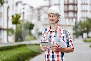 Young architect in front of apartment building