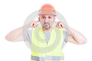 Male constructor doing hear no evil gesture