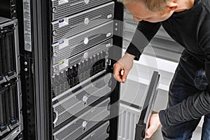 Male IT Consultant Examining SAN At Datacenter