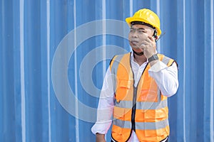 Male Container Worker  Using Walkie Talkie Radio Communication to Communicate with His Friend