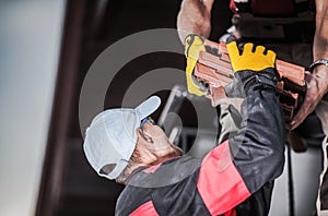 Male Contractors Unloading Ceramic Roof Tile