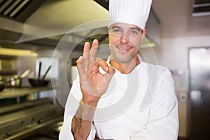 Male cook gesturing okay sign in kitchen