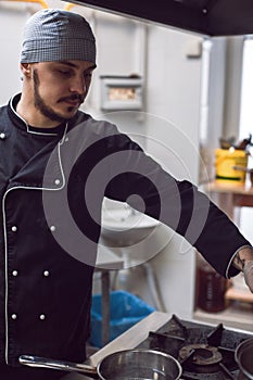 Male cook preparing meal on restaraunt kitchen