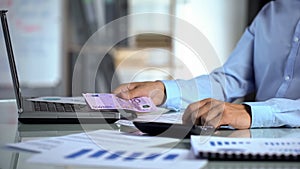 Male counting euro, company income and expenditure, business profit, budget photo