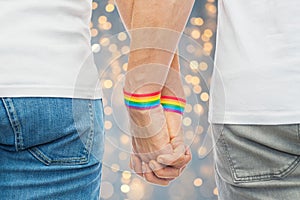 Male couple with gay pride rainbow wristbands