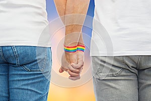 Male couple with gay pride rainbow wristbands