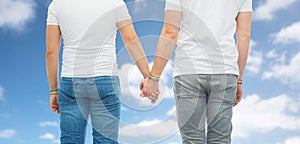 Male couple with gay pride rainbow wristbands