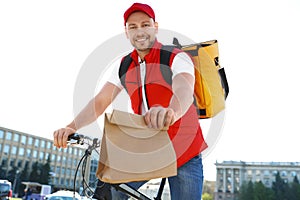 Male courier on bicycle delivering food