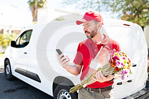 Male courier looking at the navigation map on his phone