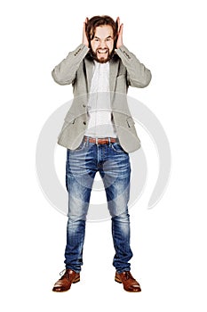 male covering his ears with his hand. emotions, facial expressions, feelings, body language, signs. image on a black studio