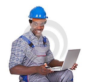 Male craftsman holding laptop
