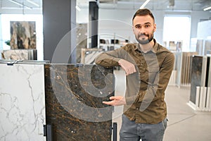 Male customer choosing kitchen ceramic tile in store