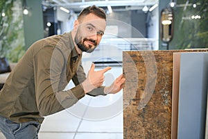 Male customer choosing kitchen ceramic tile in store