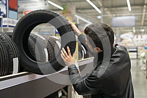 Male customer choosing new tires