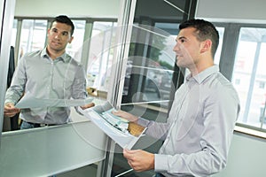 male customer looking at mirrored cuboard