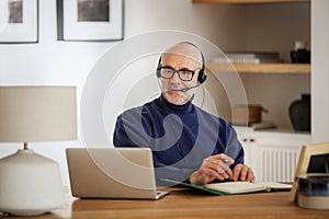 Male customer service assistant business man wearing headset and using laptop for work