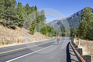 Male cyclist conquers a mountain highway while cycling in Columbia Gorge