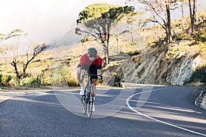 Male cyclist doing a ride on a road bike. Man in sports clothes on a bicycle