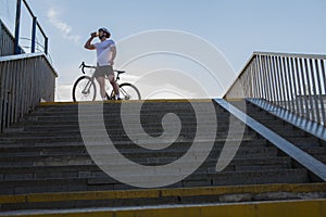 Male cyclist with his bicycle in the city