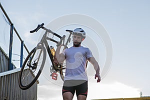 Male cyclist with his bicycle in the city