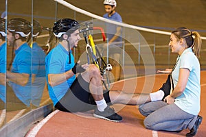 male cyclist training in velodrome with coach photo