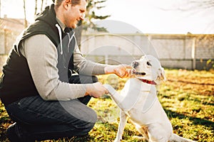 Male cynologist with trained working dog photo