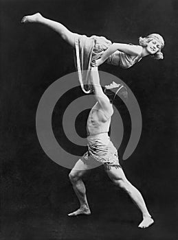 Male dancer holding female dancer aloft