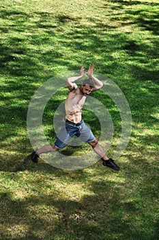 Male dancer portraying animal in dance in park