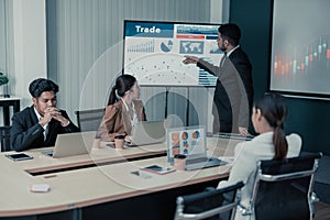 Male data analysts and supervisors analyze financial data to identify trends and investigate trade investment opportunities and