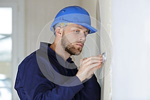 male decorator scraping wall