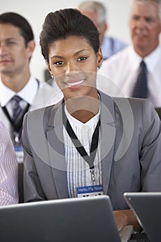 Male Delegate Listening To Presentation At Conference making Not