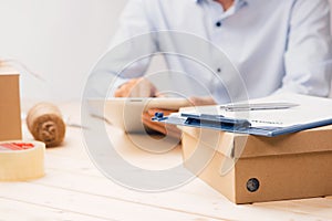 Male deliverer with tablet on work place in post office