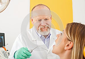 Male dentist examining radiography