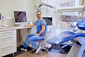 Dentist looking at teeth x-ray on the computer in a dentist office.