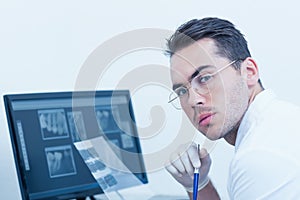 Male dentist with x-ray on computer