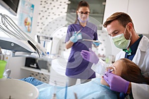 Dentist work on dental clinic with his assistant