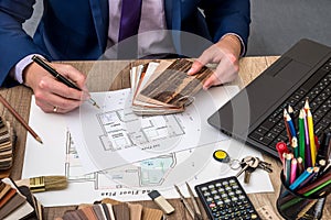 Male designer at office with wooden color swatches