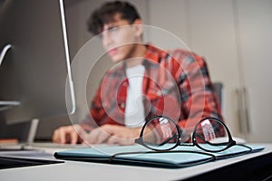 Male designer sitting in front of the imac computer photo