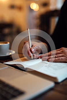 Male designer sketching web design into diary